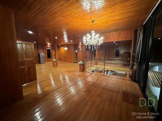 Spacious wooden living room with chandelier