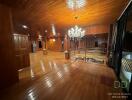 Spacious wooden living room with chandelier