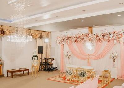 Decorated event space with pink drapery and chairs