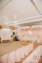 Decorated event space with pink drapery and chairs