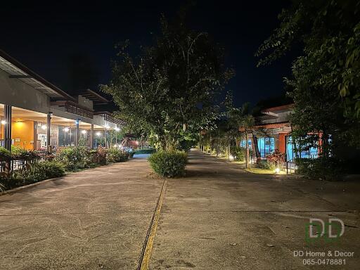 Night view of the pavement and buildings with outdoor lighting