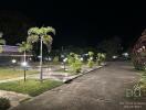 Outdoor area with parking and pathway illuminated at night