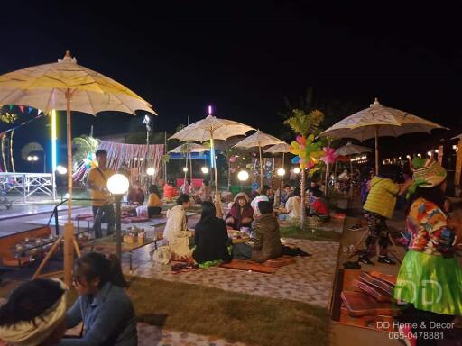 Outdoor social area with umbrellas and lights