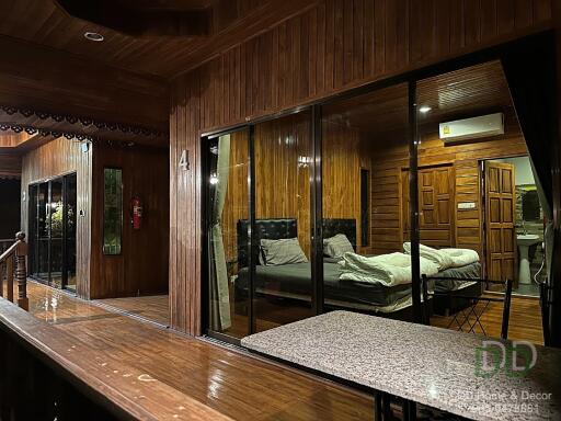 Cozy wooden bedroom view through the glass