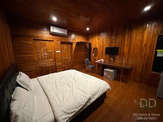 Cozy wooden bedroom with amenities