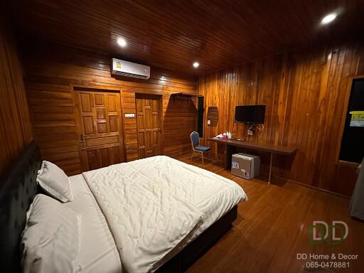 Cozy wooden bedroom with amenities