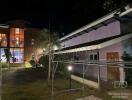 Exterior view of multiple buildings in a residential property at night