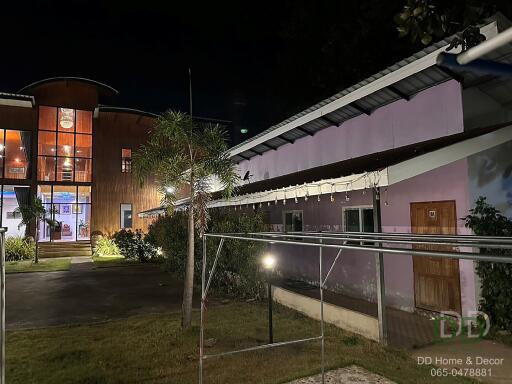 Exterior view of multiple buildings in a residential property at night