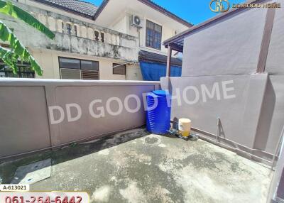 Outdoor area with concrete floor and water container