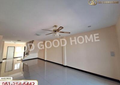 Spacious living room with ceiling fan and tiled floor