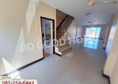 Interior view of a residential property with a staircase and bright lighting