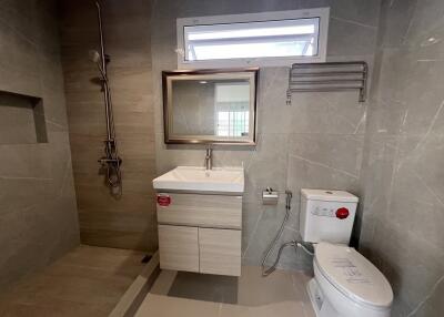 Modern bathroom with shower, sink, and toilet