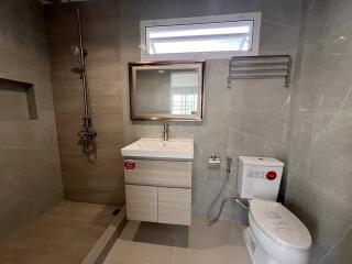 Modern bathroom with shower, sink, and toilet