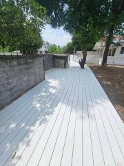 Spacious outdoor deck with surrounding greenery