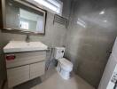 Modern bathroom with sink, mirror, and toilet