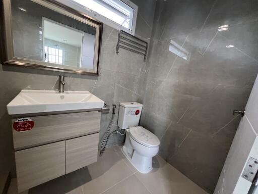 Modern bathroom with sink, mirror, and toilet