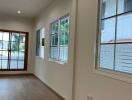 Living room with large windows and wooden flooring