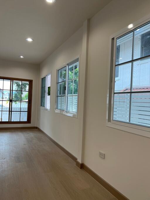 Living room with large windows and wooden flooring