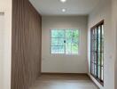 Bright living area with window and wooden flooring