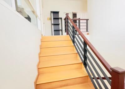Modern interior staircase with wooden steps and metal railing