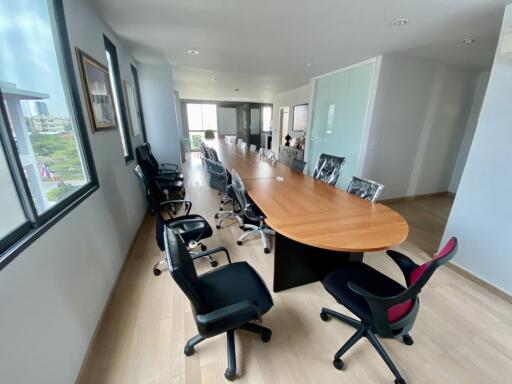 Modern conference room with a long table and multiple chairs