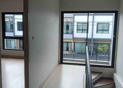 Indoor hallway with view of external buildings