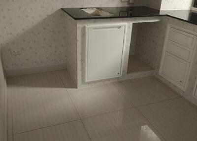 Empty kitchen with tiled walls and flooring