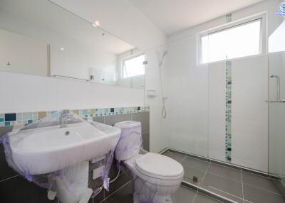 Modern bathroom with shower and tiled walls