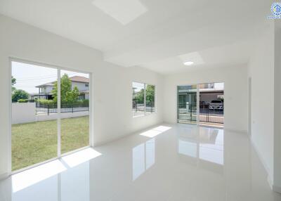 Spacious and bright living room with large windows and a view of the garden.