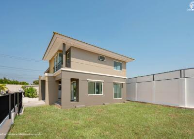 Exterior view of a two-story modern house with green lawn