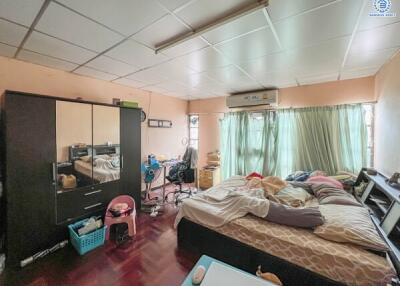 Bedroom with bed, wardrobe, desk, and natural light