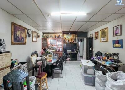 A cluttered dining room with various decorations and storage items