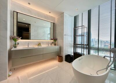 Modern bathroom with a freestanding tub and large vanity mirror