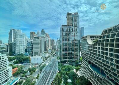 Aerial view of a large cityscape with high-rise buildings and greenery