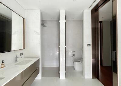 Modern bathroom with a glass-enclosed shower and toilet