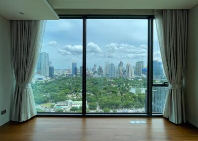 Spacious living room with large floor-to-ceiling windows offering a cityscape view