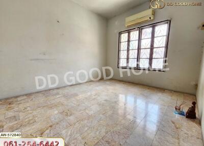 Spacious empty bedroom with tiled floor and large windows