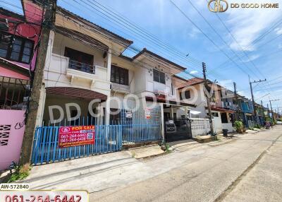 Exterior view of a residential building with multiple units for sale