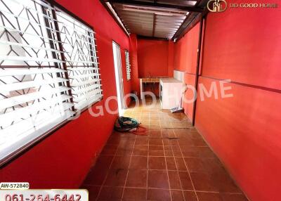 Utility or storage space with red walls and tiled floor