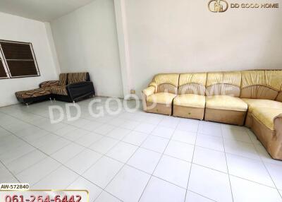 Spacious living room with white tiled floor and comfortable seating