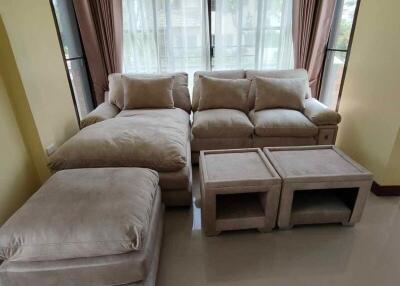 Living room with beige sofa and large windows