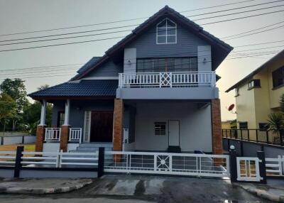 Exterior view of a modern two-story house with balcony