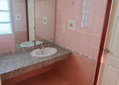 Bathroom with single sink and large mirror