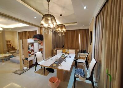 Dining room with chandelier lighting and adjacent living area