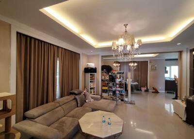 Spacious living room with stylish lighting and large sectional sofa