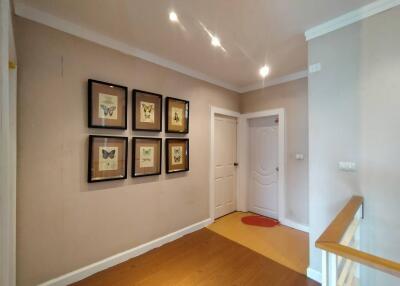 Hallway with framed artwork and doors