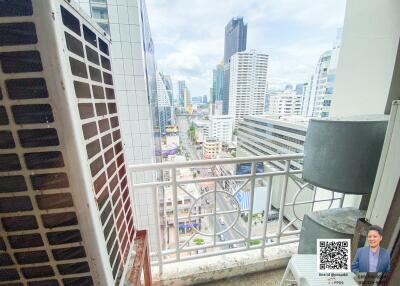 Cityscape view from balcony with railing and air conditioning units