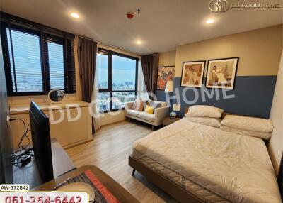 Well-lit bedroom with large window and city view