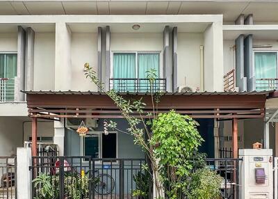 Two-story house with front yard greenery