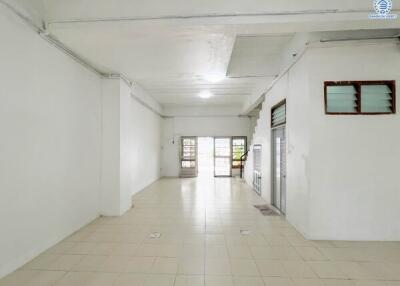 Spacious empty room with tiled floor and multiple windows